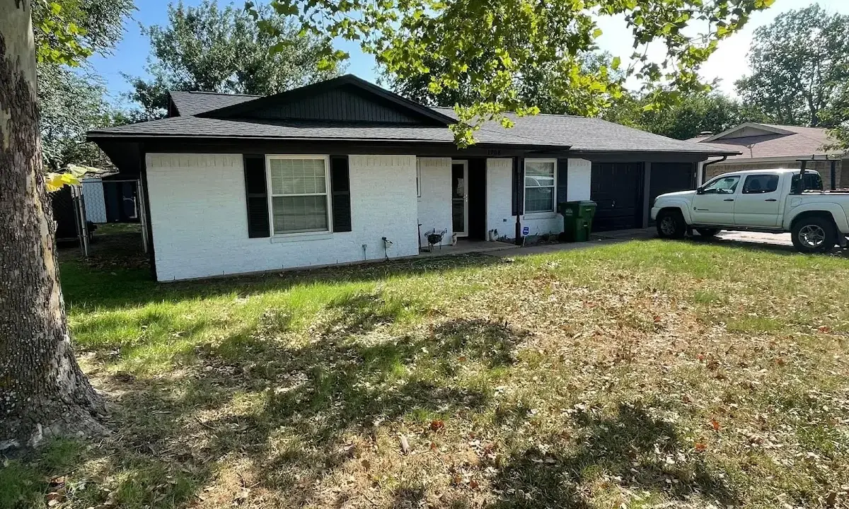 Professional roofing crew working on a residential roof in Kendall